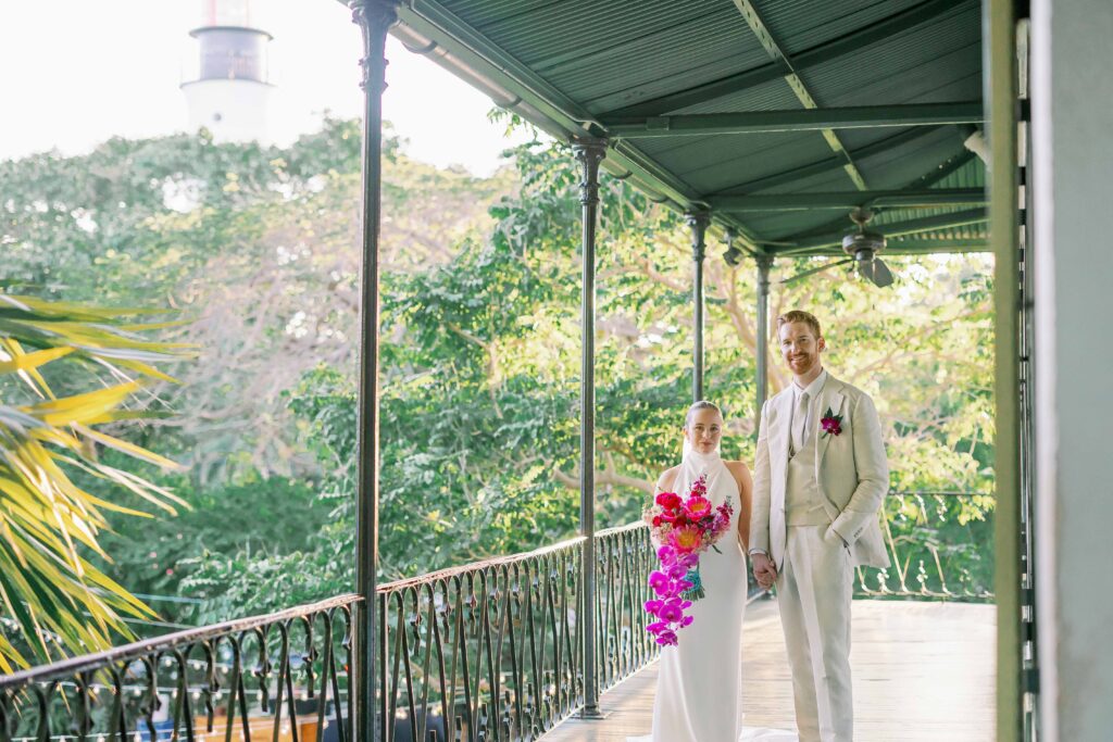 A bride and groom on the balcony of the Hemingway Home