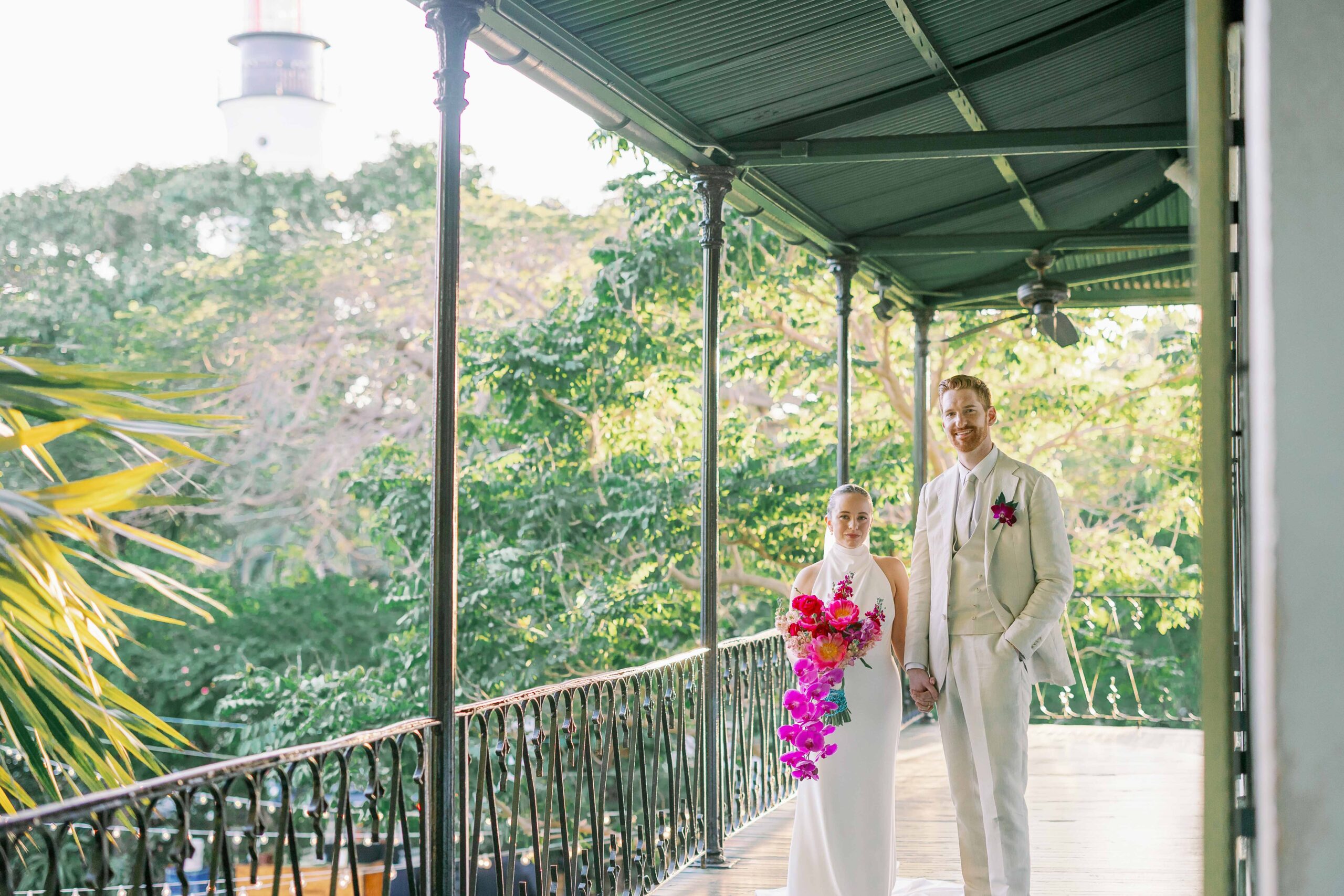 A bride and groom on the balcony of the Hemingway Home